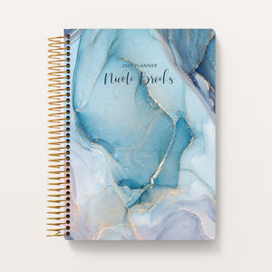 
                  
                    Aqua Gold Abstract Ink cover on a 6×9 Posy planner
                  
                