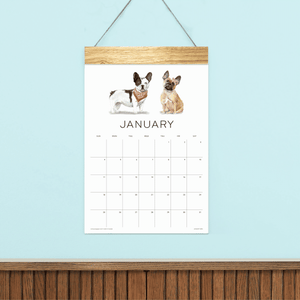 
                  
                    Animated preview of Loyal Companions wall calendar pages with illustrated dogs and a wooden hanger.
                  
                
