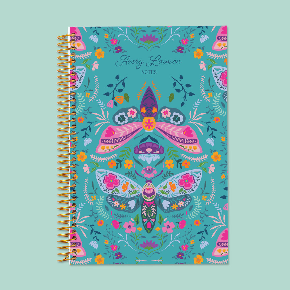Meadow Daybreak Wings personalized notebook with optional name customization, gold coil binding, and a whimsical teal floral cover featuring illustrated moths, butterflies, and garden accents.
