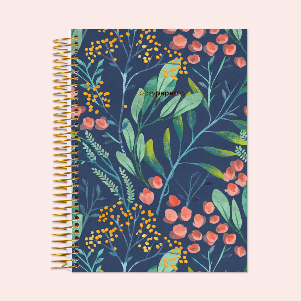 Hardcover monthly planner with a navy watercolor floral cover, featuring elegant hand-painted blossoms, spacious monthly layouts, and durable coil binding.