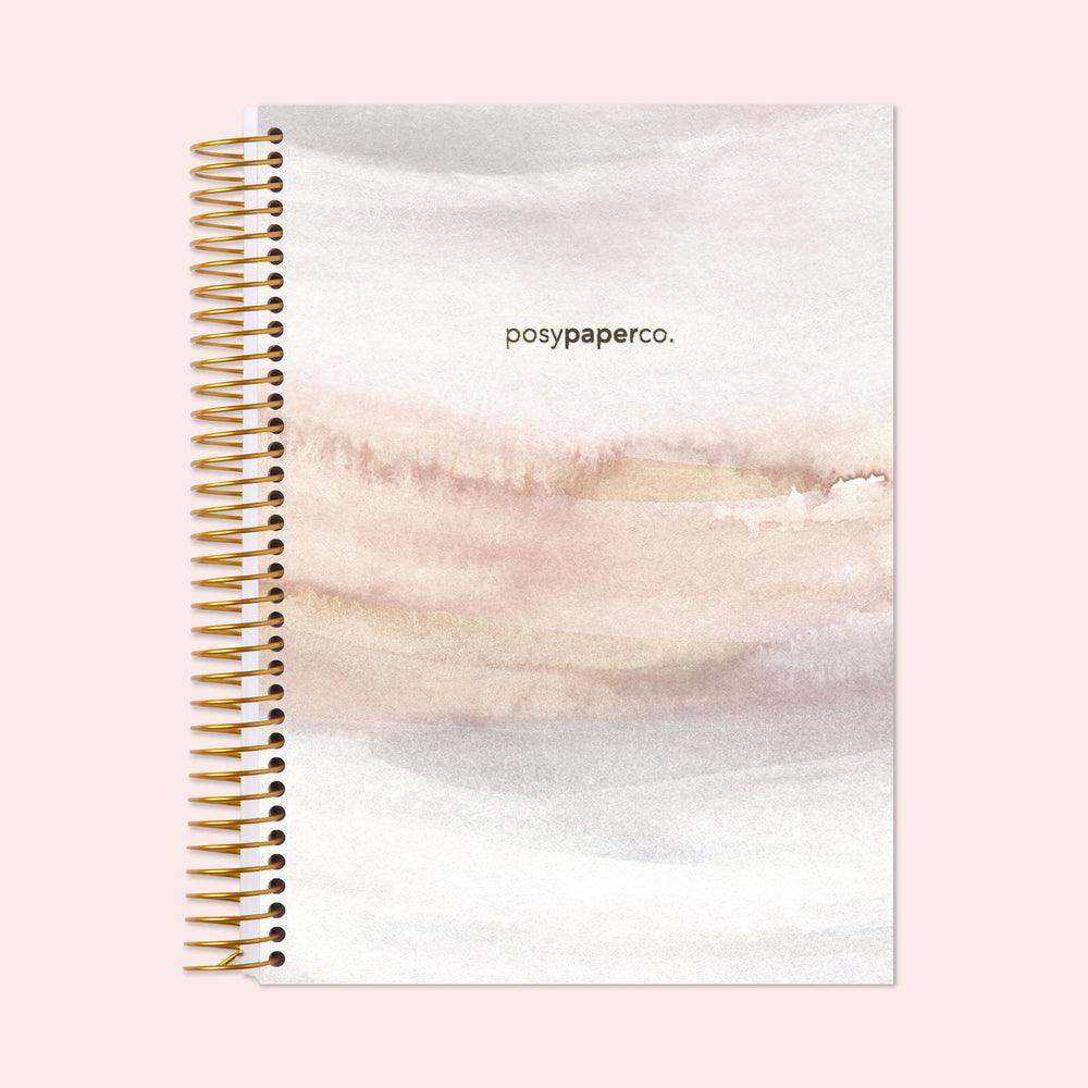 Hardcover monthly planner with a modern neutral watercolor gradient cover, designed for effective planning with monthly spreads and durable craftsmanship.