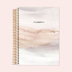 
                  
                    6×9 hardcover weekly planner with a Neutral Watercolor Gradient cover and gold coil binding.
                  
                