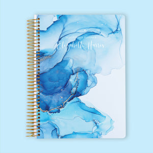 
                  
                    Fitness planner with a Blue Abstract Ink cover, a sleek and modern planner to help organize workouts and wellness routines.
                  
                