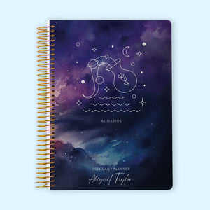 
                  
                    Daily planner with an Aquarius zodiac-themed cover, incorporating the Aquarius water-bearer symbol and cosmic elements, along with an organized daily page layout and customization features for effective planning.
                  
                