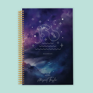 
                  
                    Aquarius zodiac notebook with a space-inspired blue and purple cover, lined pages for unconventional ideas, and strong spiral binding for everyday use.
                  
                