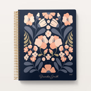 
                  
                    Secret Garden Blush & Dusk cover on an 8.5×11 weekly planner
                  
                