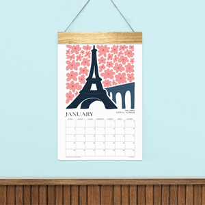 
                  
                    Animated preview of Travel wall calendar pages with illustrated landmarks and a wooden hanger.
                  
                