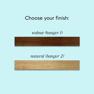 
                  
                    Wall calendar hanger options showing walnut and natural wood finishes.
                  
                