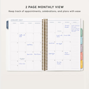 
                  
                    Two-page January 2027 monthly calendar spread inside a 6×9 daily planner, with notes column and month tabs.
                  
                