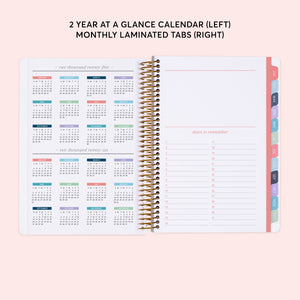 
                  
                    a planner with a calendar on top of it
                  
                