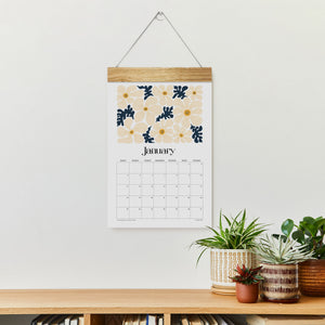 
                  
                    Artful Florals January wall calendar hanging above a console
                  
                