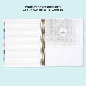 
                  
                    a notebook with a planner and pen on top of it
                  
                