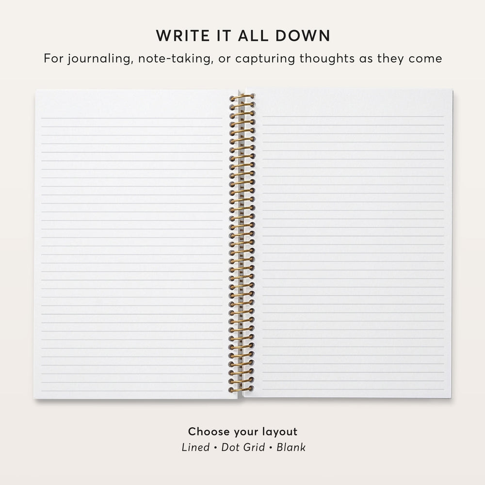 
                  
                    a blank spiral-bound notebook with a gold-colored spiral binding.
                  
                