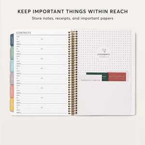 
                  
                    Daily planner contact page beside a back pocket holding cards.
                  
                
