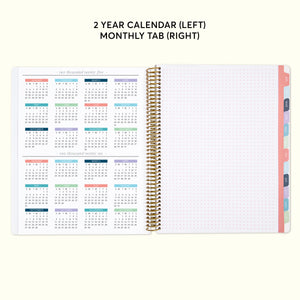 
                  
                    a planner with a calendar on top of it
                  
                