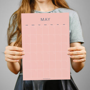 
                  
                    Person holding a pink May sheet from the pastel undated wall calendar
                  
                