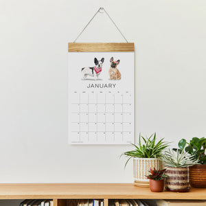 
                  
                    Loyal Companions January wall calendar hanging above a console
                  
                