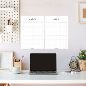 
                  
                    White March and April undated wall calendar sheets above a desk
                  
                