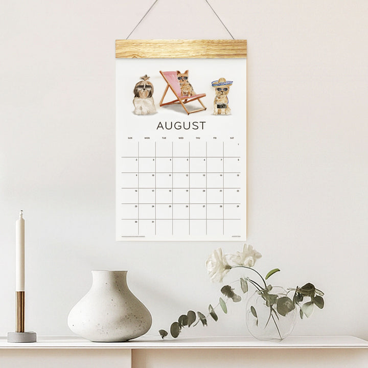 Loyal Companions August wall calendar with illustrated dogs above a shelf