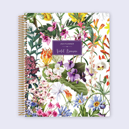 8.5x11 student planner with a vibrant floral cover on white, structured for school planning, class tracking, and goal-setting sections.