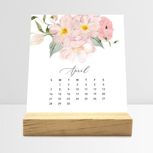 
                  
                    April Flirty Florals desk calendar card with watercolor flowers in a wooden stand.
                  
                