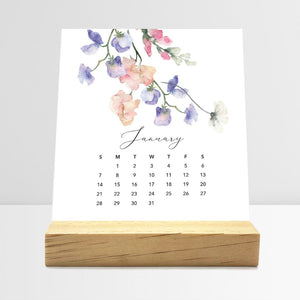 
                  
                    January Flirty Florals desk calendar card with watercolor flowers in a wooden stand.
                  
                