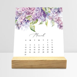 
                  
                    March Flirty Florals desk calendar card with watercolor flowers in a wooden stand.
                  
                