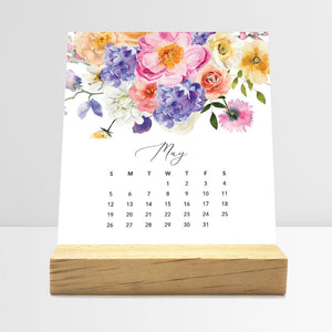 
                  
                    May Flirty Florals desk calendar card with watercolor flowers in a wooden stand.
                  
                