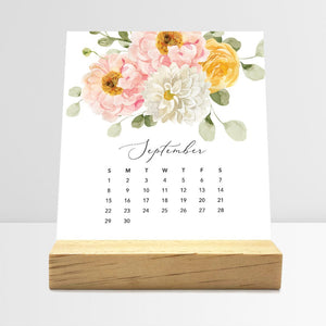 
                  
                    September Flirty Florals desk calendar card with watercolor flowers in a wooden stand.
                  
                