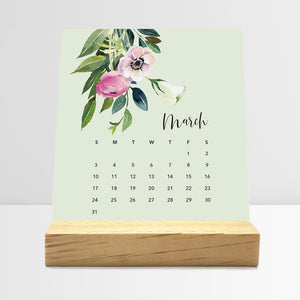 
                  
                    March Floral desk calendar card with watercolor flowers in a wooden stand.
                  
                