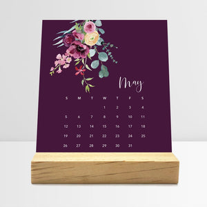 
                  
                    May Floral desk calendar card with watercolor flowers in a wooden stand.
                  
                