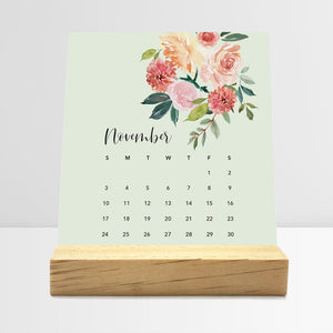 
                  
                    November Floral desk calendar card with watercolor flowers in a wooden stand.
                  
                