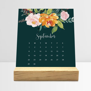 
                  
                    September Floral desk calendar card with watercolor flowers in a wooden stand.
                  
                