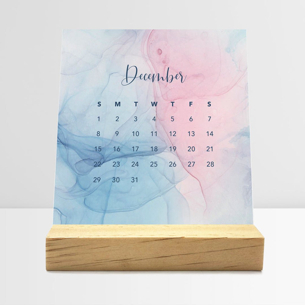 
                  
                    Posy Paper Co. 2024 desk calendar with flowing ink design displaying December dates.
                  
                