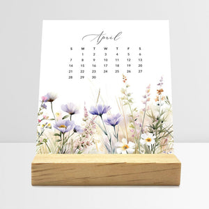 
                  
                    April Meadow Floral desk calendar card with watercolor flowers in a wooden stand.
                  
                
