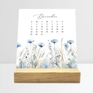 
                  
                    December Meadow Floral desk calendar card with watercolor flowers in a wooden stand.
                  
                