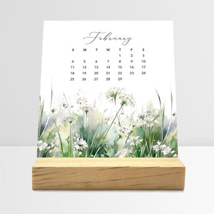 
                  
                    February Meadow Floral desk calendar card with watercolor flowers in a wooden stand.
                  
                