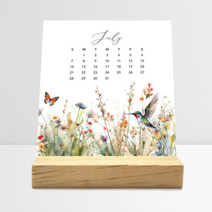 
                  
                    July Meadow Floral desk calendar card with watercolor flowers in a wooden stand.
                  
                