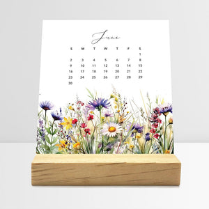 
                  
                    June Meadow Floral desk calendar card with watercolor flowers in a wooden stand.
                  
                